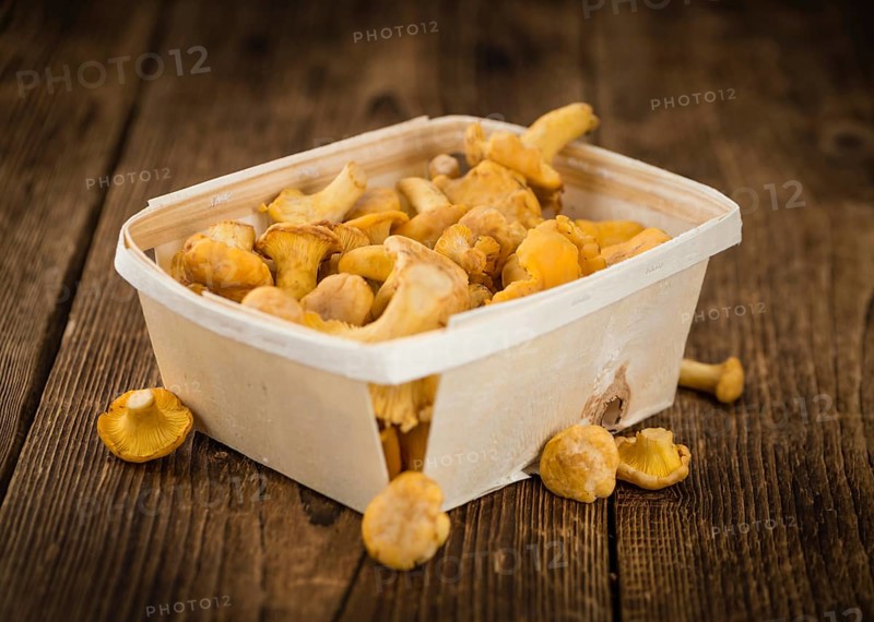 Chanterelles as high detailed close-up shot on a vintage wooden table, selective focus