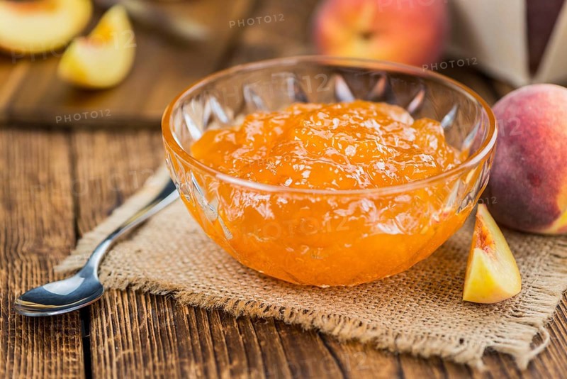 Portion of fresh Peach Jam close-up shot, selective focus