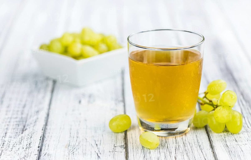 Wooden table with Grape Juice (detailed close-up shot, selective focus)