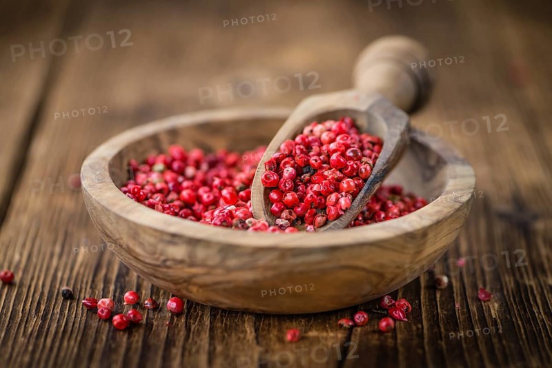 Pink Peppercorns on a vintage background as detailed close-up shot, selective focus