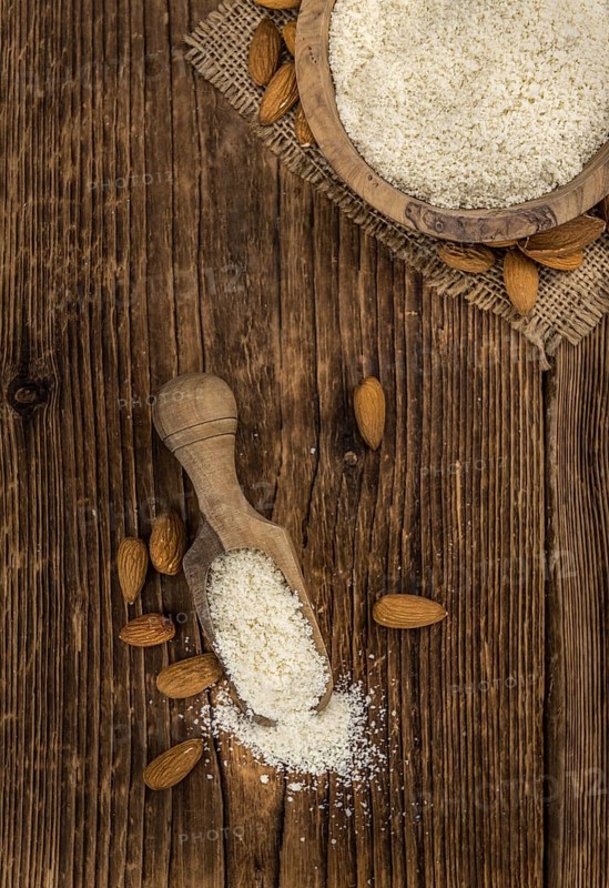 Portion of fresh Powdered Almonds on an old wooden table