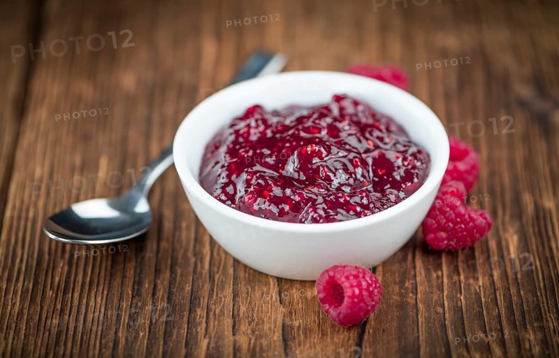 Some homemade Raspberry Jam as detailed close-up shot, selective focus