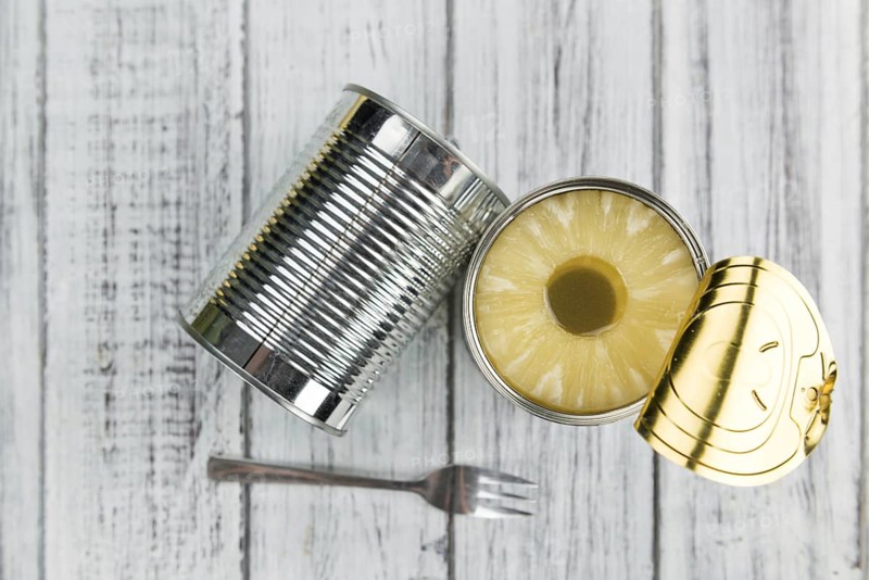 Fresh made Preserved Pineapple Rings on a vintage background as detailed close-up shot