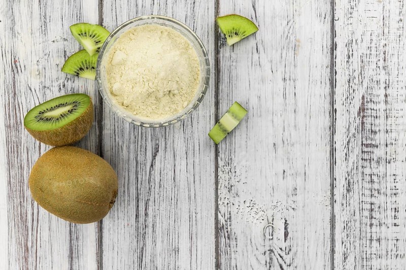Fresh made Kiwi powder (slective focus, close-up shot) on an old wooden table
