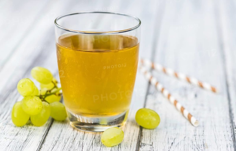 Wooden table with Grape Juice (detailed close-up shot, selective focus)