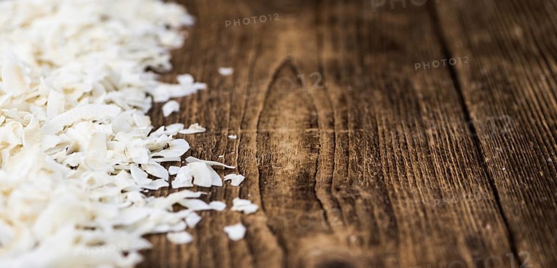 Fresh Coconut Flakes as detailed close-up shot (selective focus)