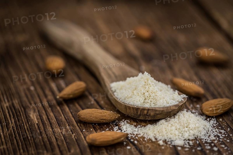 Wooden table with Almond Flour (detailed close-up shot, selective focus)
