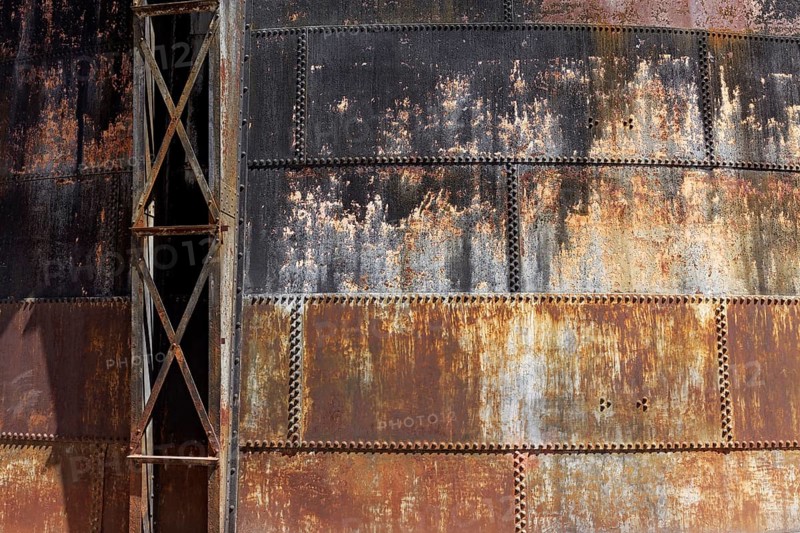 Riveted walls of an old gas storage tank, covered with rust, industrial monument Athens Gasworks from 1875, Gazi district, Athens, Greece, Europe