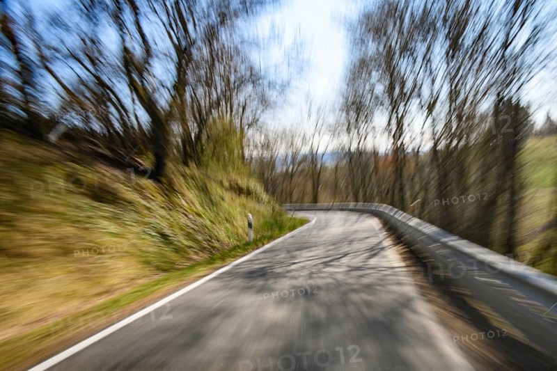 Symbolic image for speeding dangerous driving at excessive speed by speeders on dangerous narrow winding country road without central reservation, Germany, Europe