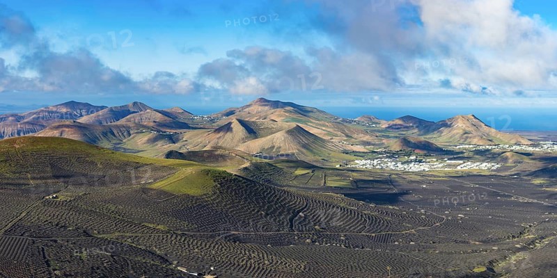 Panorama at sunrise from Montana de Guardilama to the wine-growing region of La Geria, with the villages of Uga and Yaiza behind, Lanzarote, Canary Islands, Spain, Europe