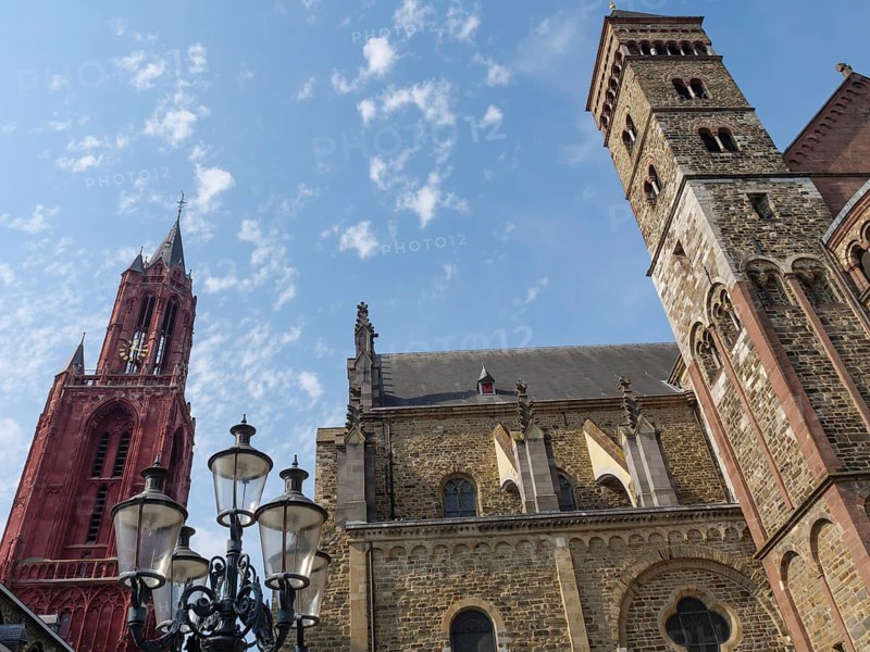 Church ensemble with Gothic towers and lanterns under a sunny sky, Maastricht, Limburg, Netherlands