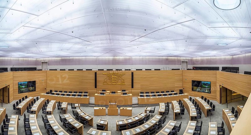State parliament of Baden-Württemberg, assembly hall with state coat of arms. The seats of the members of parliament and ministers are empty. Stuttgart, Baden-Württemberg, Germany, Europe