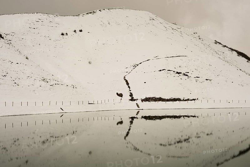 After snowfall in May: Riezler Alpsee, an artificial lake, snow pond, feeds the snow cannons that completely cover the slopes of the Fellhorn and Kanzelwand cable cars with snow, Allgäu Alps, Vorarlberg, Austria, Europe