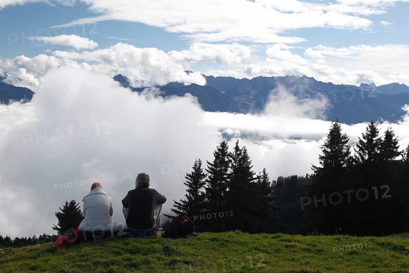 Hikers resting above the clouds on the Horner Group