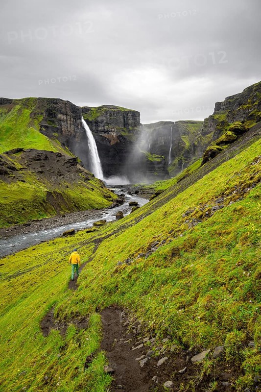 Hikers in a green canyon, Haifoss and Granni waterfall at a canyon, Fossá í Thjórsárdal, with river í Thjórsárdal, long exposure, dramatic landscape, Hekla, Iceland, Europe