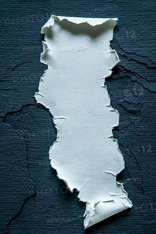 A piece of torn paper with ripped edges placed on a dark background, creating a strong contrast, AI generated