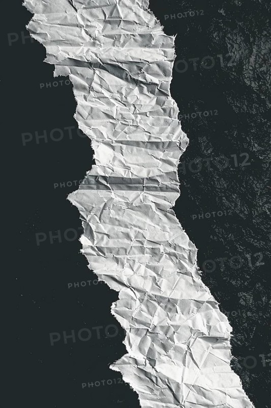 Crumpled paper creating a curved path with strong contrast between black and white, evoking texture and abstract aesthetic, AI generated