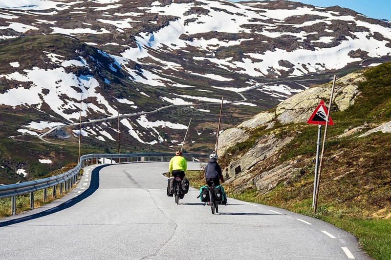 Cyclists on mountain crossing Sognefjellsvegen, mountain pass over the Sognefjellet, touristic road, at Nedre Oscarshaug viewpoint, Norway, Europe