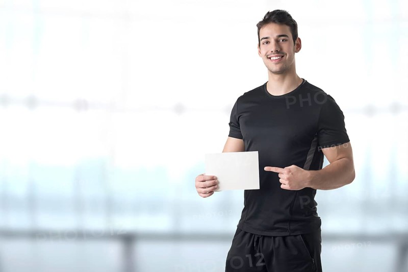 Male Personal Trainer Holding an Empty Card