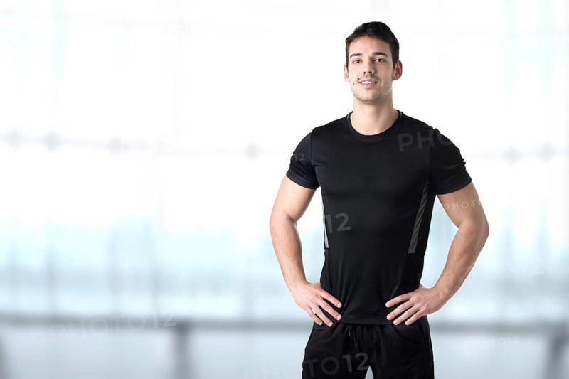 Personal Trainer With Hands on Waist in a Gym