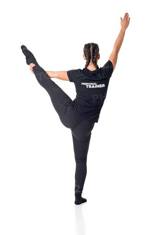 Personal Trainer standing with one leg up, isolated in white