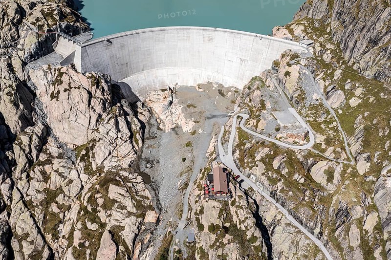 Aerial view of reservoir dam Barrage du Vieux Emosson and mountain hut Cabane Vieux Emosson, Finhaut, Switzerland, Europe