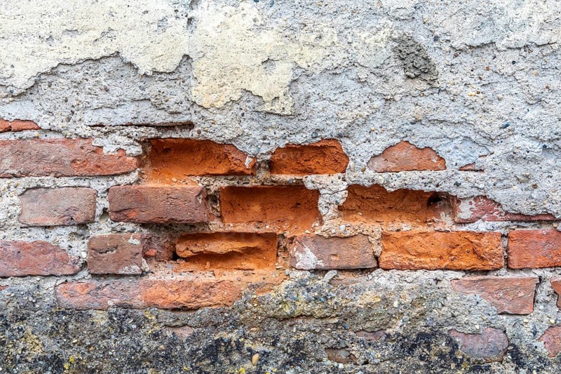 Old wall with crumbling plaster