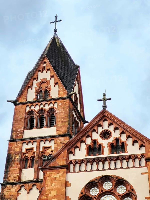 St Lutwinus Church in Mettlach is a Catholic parish church built in the neo-Gothic style. The church has two towers and a rose window. Mettlach, Merzig-Wadern, Saarland, Germany, Europe