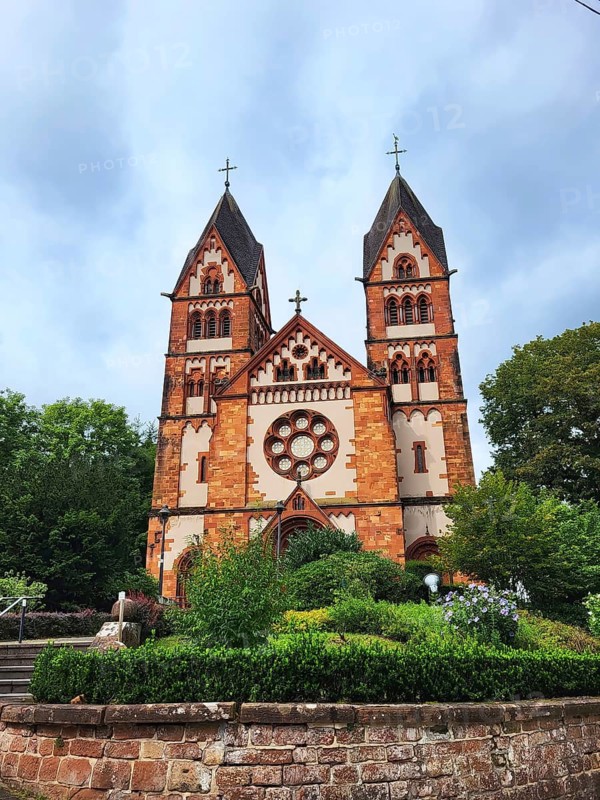 St Lutwinus Church in Mettlach is a Catholic parish church built in the neo-Gothic style. The church has two towers and a rose window. Mettlach, Merzig-Wadern, Saarland, Germany, Europe