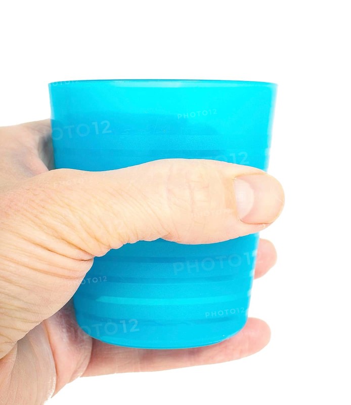 Empty blue plastic glass, held in a male persons hand