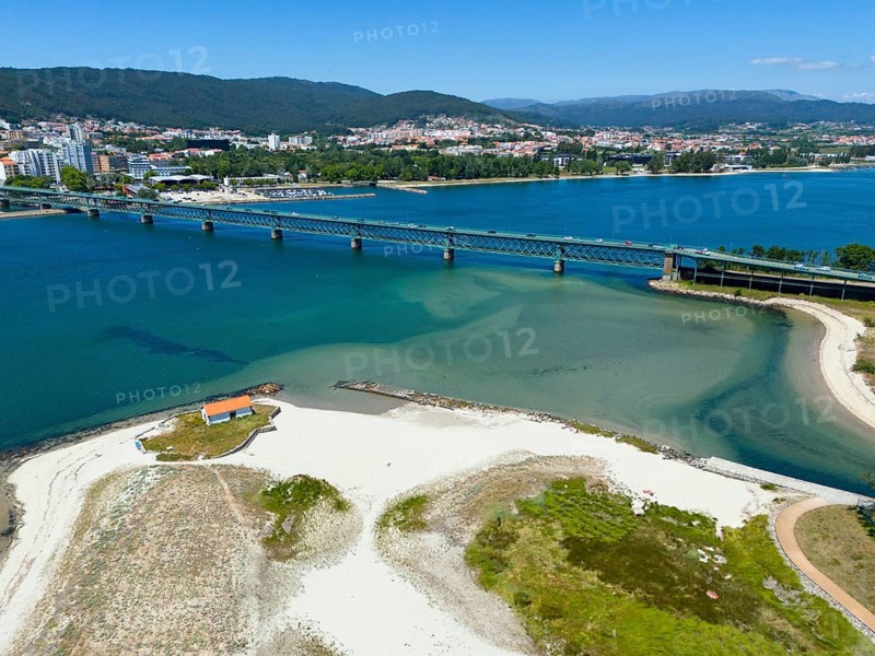 View of a coastal town with a bridge over a river flowing into the ocean, surrounded by hills and white sandy beach, aerial view, Ponte Eiffel, bridge by Gustave Eiffel, Lima River, Viana do Castelo, Portugal, Europe