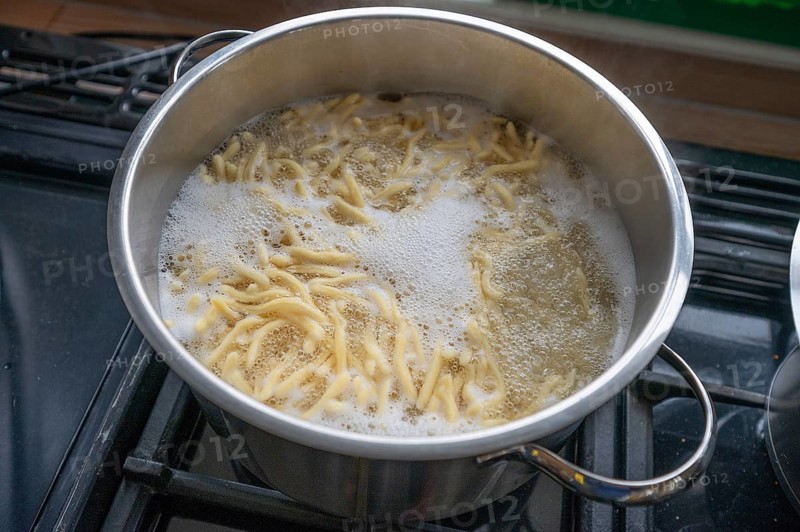 Boiling spaetzle in a pot, Bavaria Germany