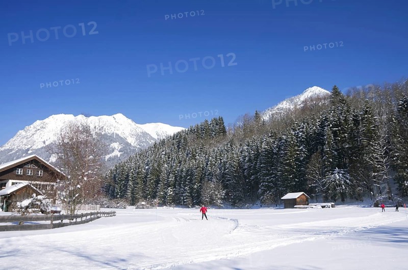 People on cross country ski-run in village