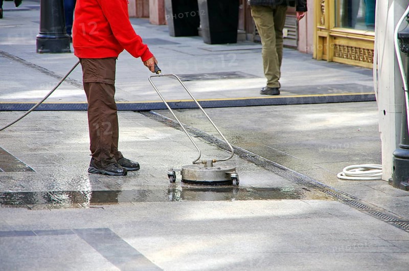 Road sweeper cleaning granite stone floor
