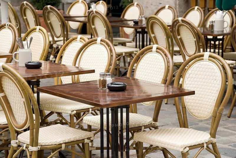 Typical munich stgreet cafe with wicker chairs