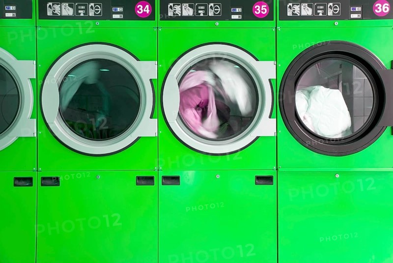 Green clothes washers in a laundrette