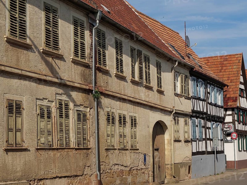 Old buildings and half-timbered houses along a sunny street with weathered shutters, Kandel, Palatinate, Germany, Europe