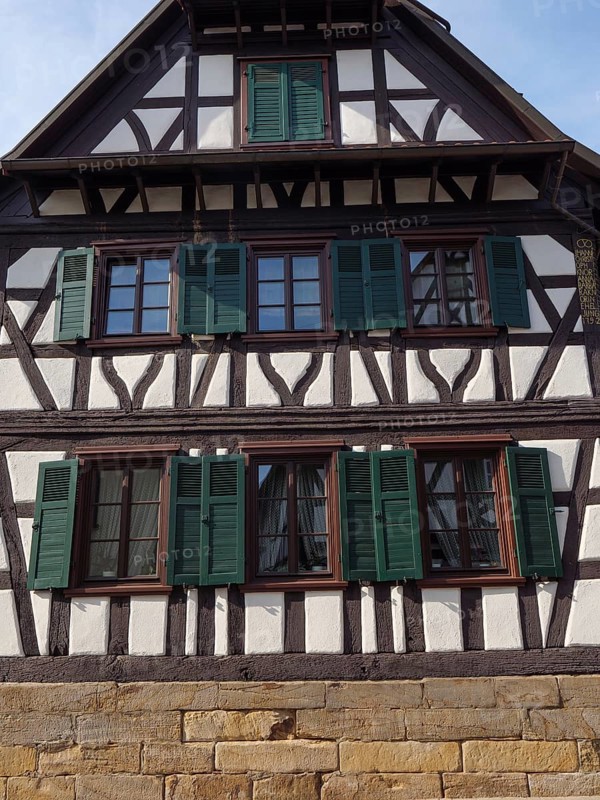 Traditional half-timbered house with green shutters and wooden structure, Kandel, Palatinate, Germany, Europe