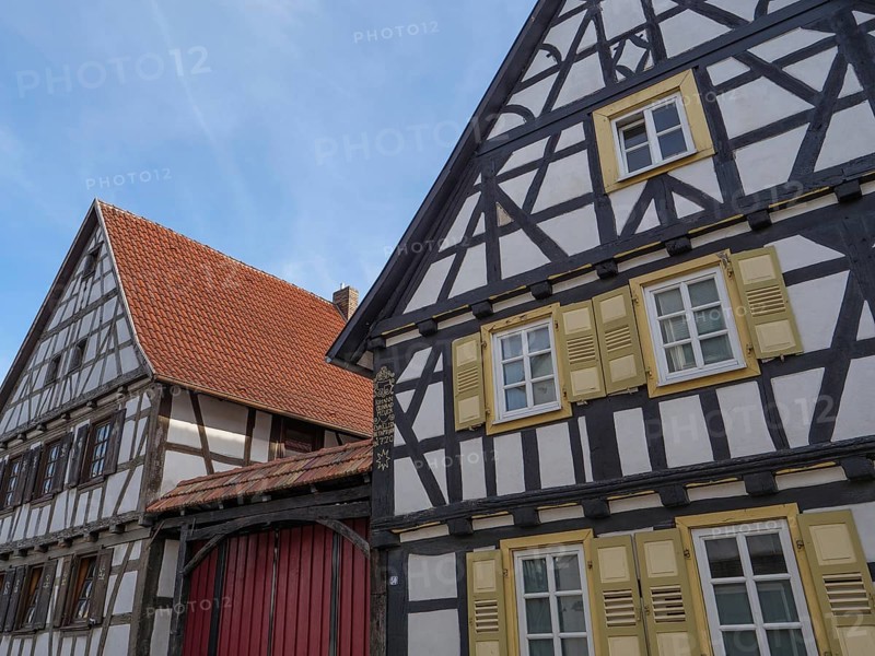 Traditional half-timbered houses with red roofs and shutters in a sunny daytime atmosphere, Kandel, Palatinate, Germany, Europe
