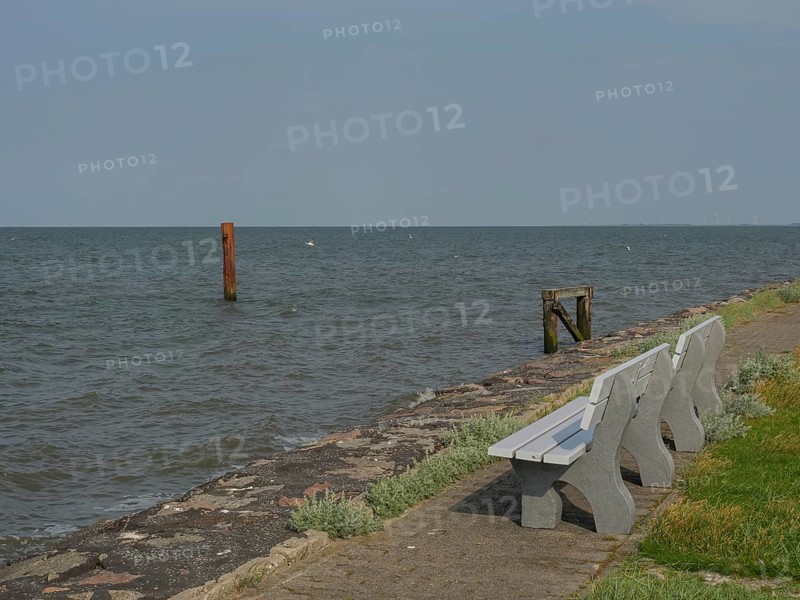 Benches along a stone path on the seashore, hallig hooge, schleswig-holstein, germany
