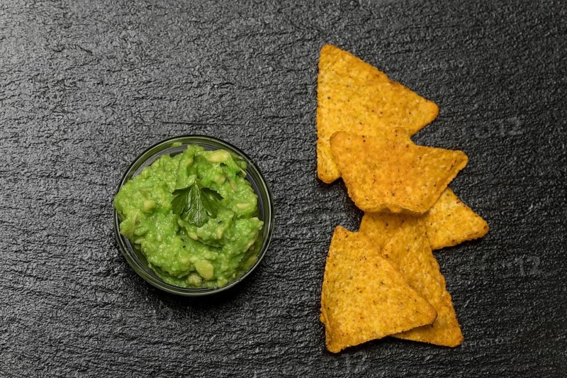 Small portion of guacamole on slate