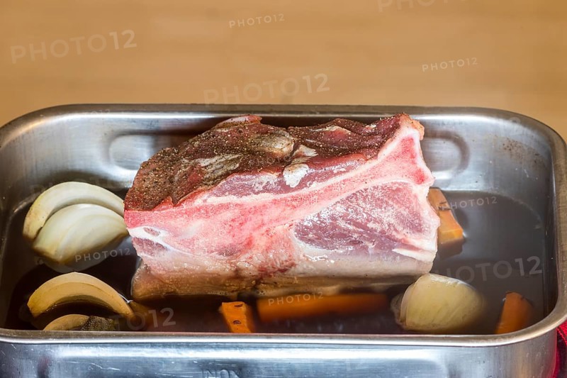 Raw pork shoulder in a casserole