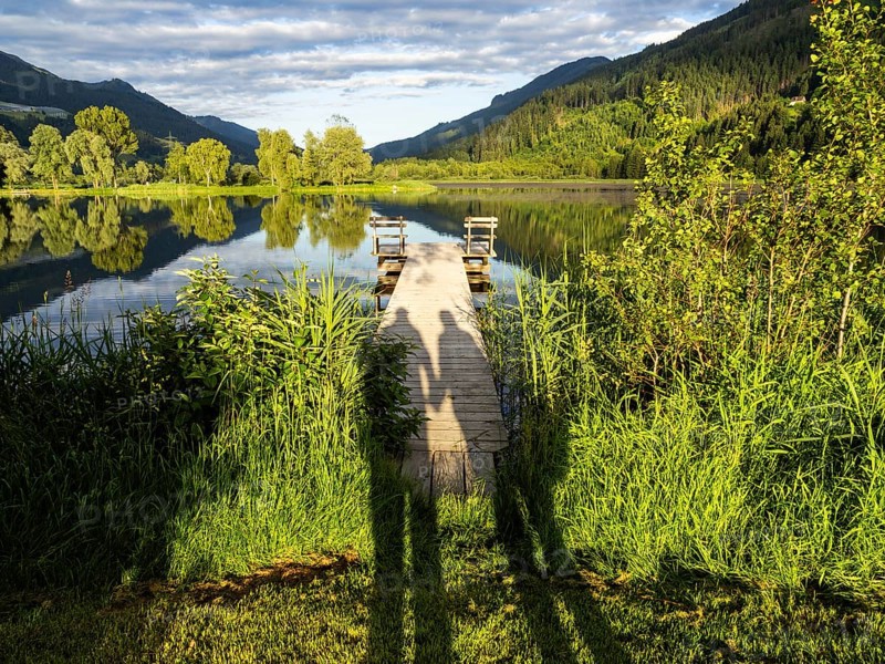 Shadow of a couple on a jetty, Gaishorner See in the evening light, Gaishorn am See, Paltental, Styria, Austria, Europe