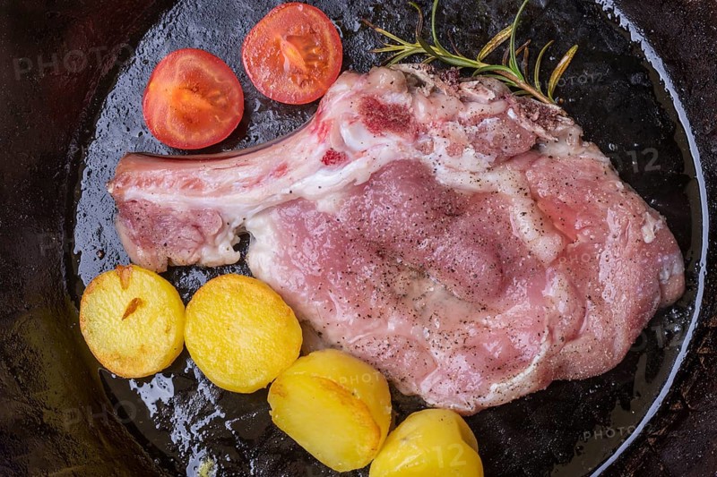 Veal escalope in an iron pan