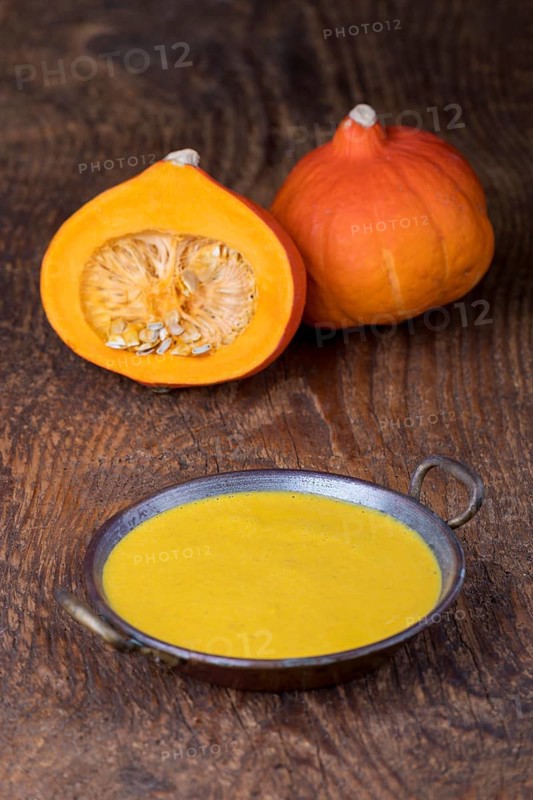 Close-up of pumpkin soup on wood