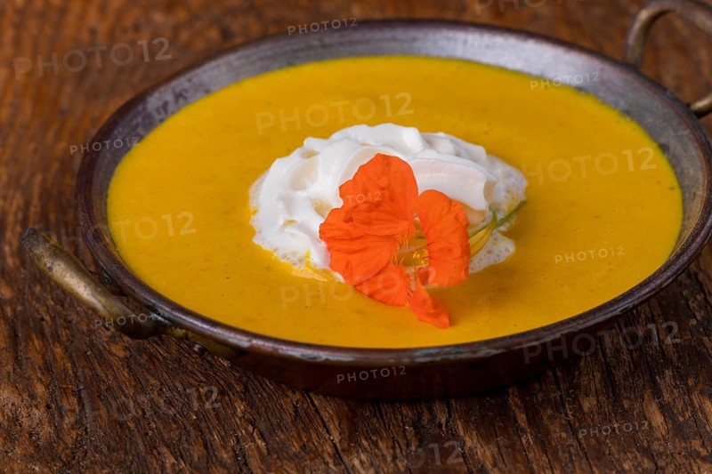 Close-up of pumpkin soup on wood