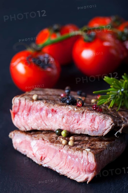 Juicy cut steak on a slate plate
