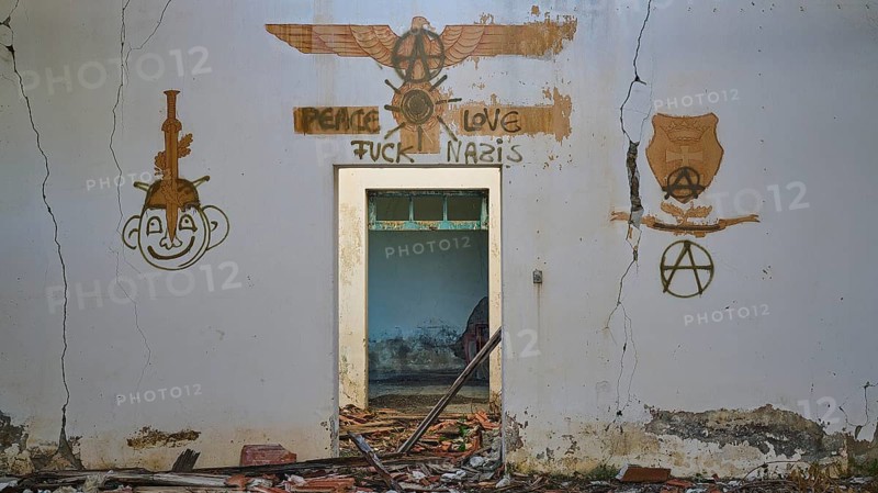 A graffiti with several artworks and a message of peace can be seen on a cracked white wall of an abandoned building, Lost Place, World War II bunker, barrack, Kalavarda, Rhodes, Dodecanese, Greek Islands, Greece, Europe