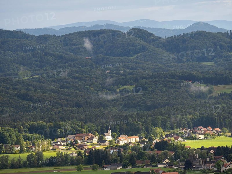 Evening light falls on the village of Heimschuh, hilly forest landscape, near Leibnitz, Styria, Austria, Europe