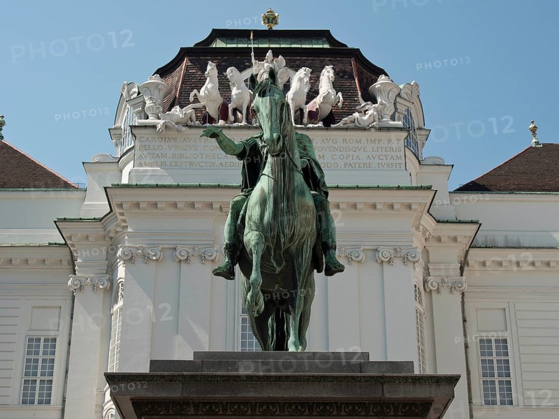 Equestrian statue in front of a magnificent baroque building with decorative elements, Vienna, Austria, Europe